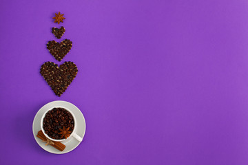 Cup of coffee seeds and coffee hearts with spices