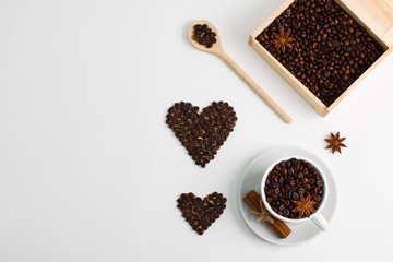 Cup of coffee seeds cinnamon anis hearts wooden box spoon