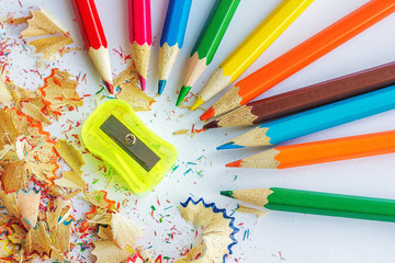 Color pencils, shavings from pencils and a sharpener