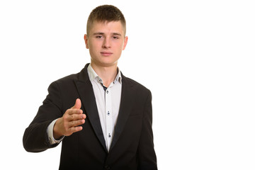 Studio shot of young businessman giving handshake