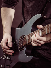 Male hands playing electric guitar