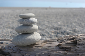Fototapeta na wymiar stones stack in zen style on the beach on sunny day.