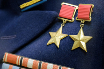 Fototapeta premium Shallow depth of field. The symbol of the highest degree of distinction between the warrior of the USSR: twice the hero of the Soviet Union. Medals of the times of the Great Patriotic War.