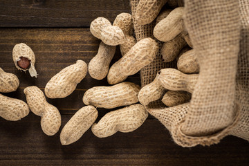 Rustic Style Peanuts in Shells on Wooden Background with Copy Space