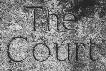 The Court Word Carved In Stone, shallow depth of field black and white high contrast photography