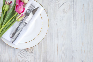 Festive table setting with bouquet of tulips