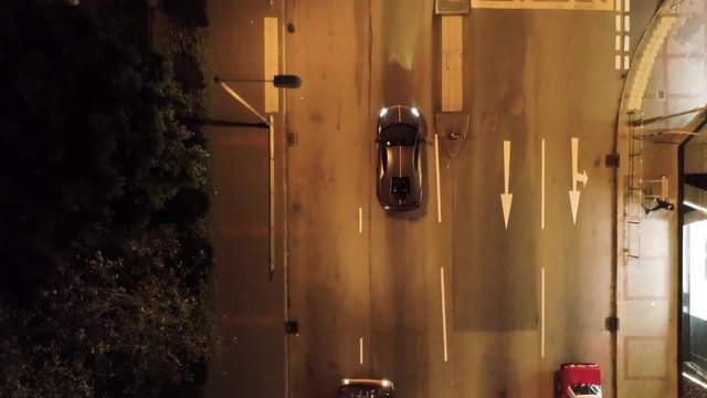 Top view on car in the Hong Kong at night. Stock. Lamborghini is driving in the city on the night road