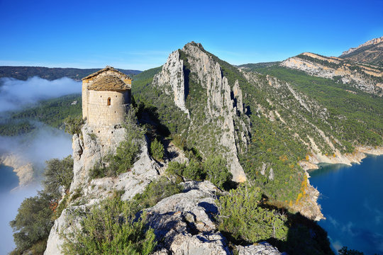 Romanesque Chapel of Mare de Deu de la Pertusa over the Canelles reservoir in Lleida, Catalonia, Spain.