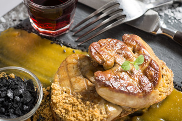 Prepared Fried Foie Gras with Mango Puree on Dark Background. Goose Liver.