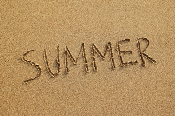 Inscription on a wet sand (Summer) on a sunset, top view.