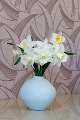 White daffodils in a vase on a table