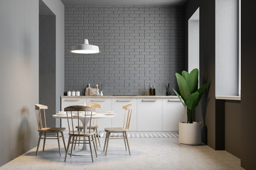Small gray brick kitchen and dining room