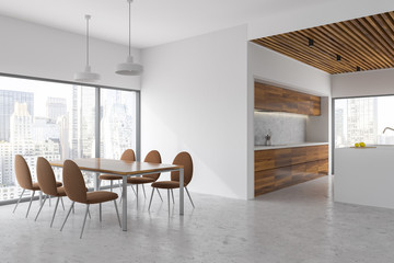 White and wood dining room and kitchen, city view