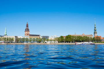 view of the spires of the cathedrals of Riga and Riga castle in the old town from river Daugava