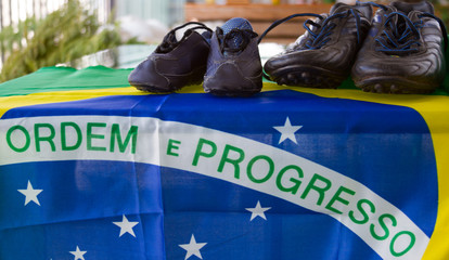 World cup - Baby's and   father's soccer cleats shoes on the Brazilian flag