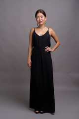 Young beautiful Kazakh woman against gray background