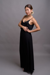 Fototapeta premium Young beautiful Kazakh woman against gray background