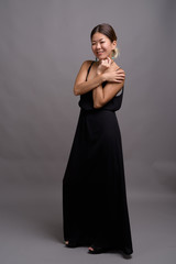 Fototapeta premium Young beautiful Kazakh woman against gray background
