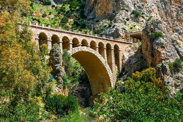 Fototapeta na wymiar stone railway bridge in the village of el chorro at the end of trail of Caminito Del Rey