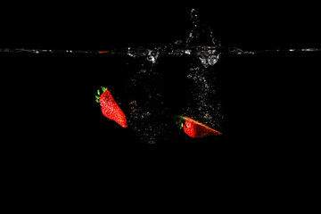 Strawberry in water black background