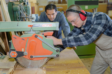 Fototapeta na wymiar carpenter with apprentice in training period