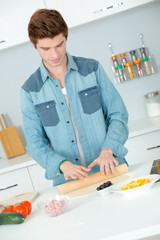 young man cooking at home