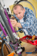 Fototapeta na wymiar business owner repairing bicycle