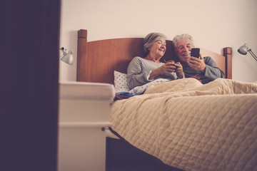 nice beautiful models couple of adult senior 70 years old having fun and enjoy in bed at home in...
