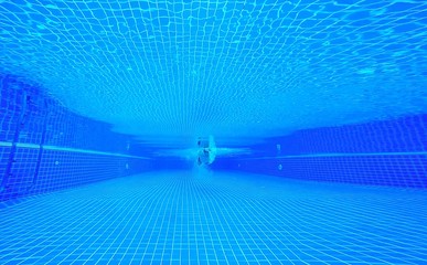 Underwater shot of fit swimmer training in the swimming pool.Amateur male swimmer practicing inside the club house pool.Sport , Health care concept.Copy space for text.