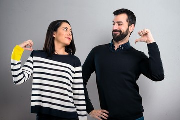 Couple proud of themselves on grey background