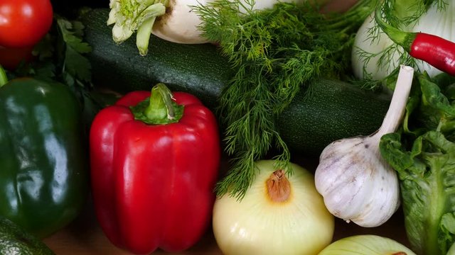 Close up of various healthy vegetables captured in slow motion on kitchen table. Natural dieting food concept.
