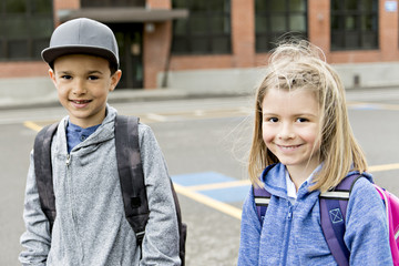 Two students outside at school standing together