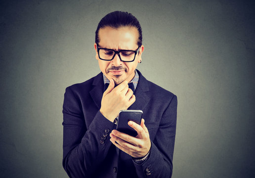 Confused man having problems with smartphone