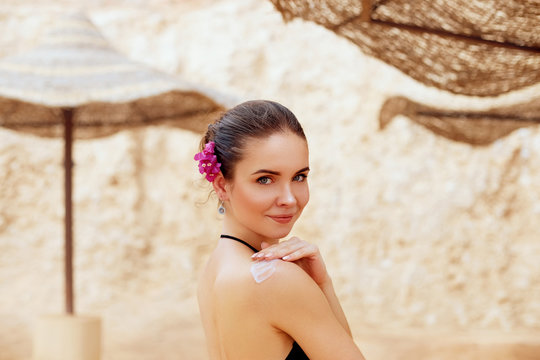 Woman applying sunscreen on a sunny day