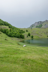 Rain clouds are approaching the mountain lake.