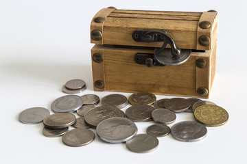 coins and wooden box on the white background for investment concept.to save money is a child's play.