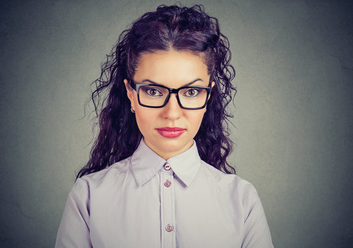 Serious young woman in glasses