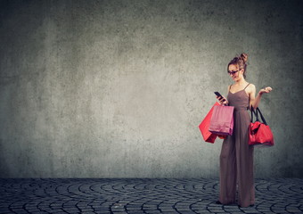 Happy woman with bags shopping online