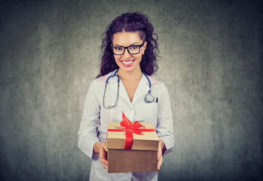 Smiling doctor having present box