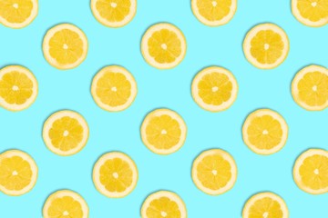 Colorful fruit pattern, Lemon slices on a pastel blue background. Top view.