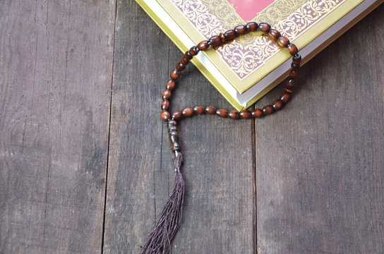 Holy islamic book Koran on the draped table with a rosary. Ramadan Kareem beautiful poster, banner, postcard for the celebration of the festival of the Muslim community
