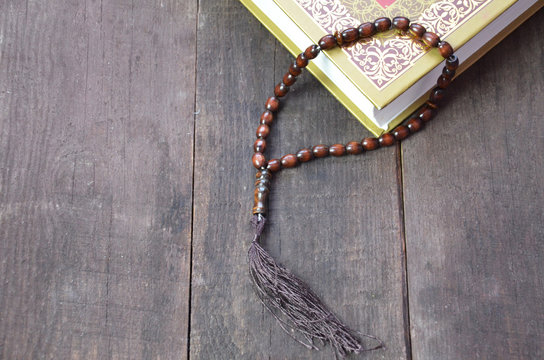 Holy islamic book Koran on the draped table with a rosary. Ramadan Kareem beautiful poster, banner, postcard for the celebration of the festival of the Muslim community