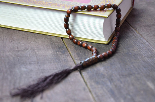 Holy islamic book Koran on the draped table with a rosary. Ramadan Kareem beautiful poster, banner, postcard for the celebration of the festival of the Muslim community