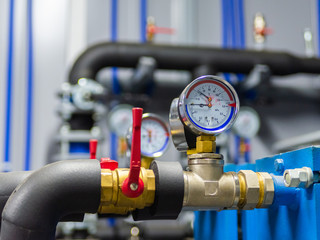 Industrial water temperature and pressure meter on pipe