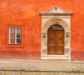 Antique entrance in a red wall