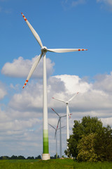Fototapeta premium Four wind turbines against a sunny sky