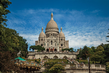 Fototapeta na wymiar Staircase, domes and facade of the Basilica of Sacre Coeur at the Montmartre district in Paris. Known as the “City of Light”, is one of the most impressive world’s cultural center. Northern France.