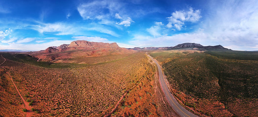 AERIAL VIEW OF DESERT, ROCKS, MOUNTAINS, ROAD AND CACTUSES IN ARIZONA, USA. DRONE SHOT, PANORAMA .