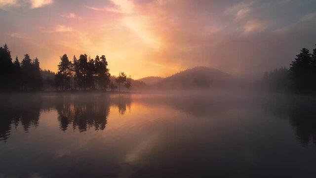 Aerial view of morning fog on the lake, sunrise shot.