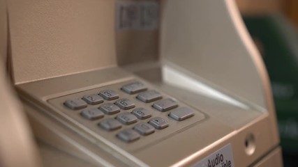 Young female hand putting in pin code for ATM 4k